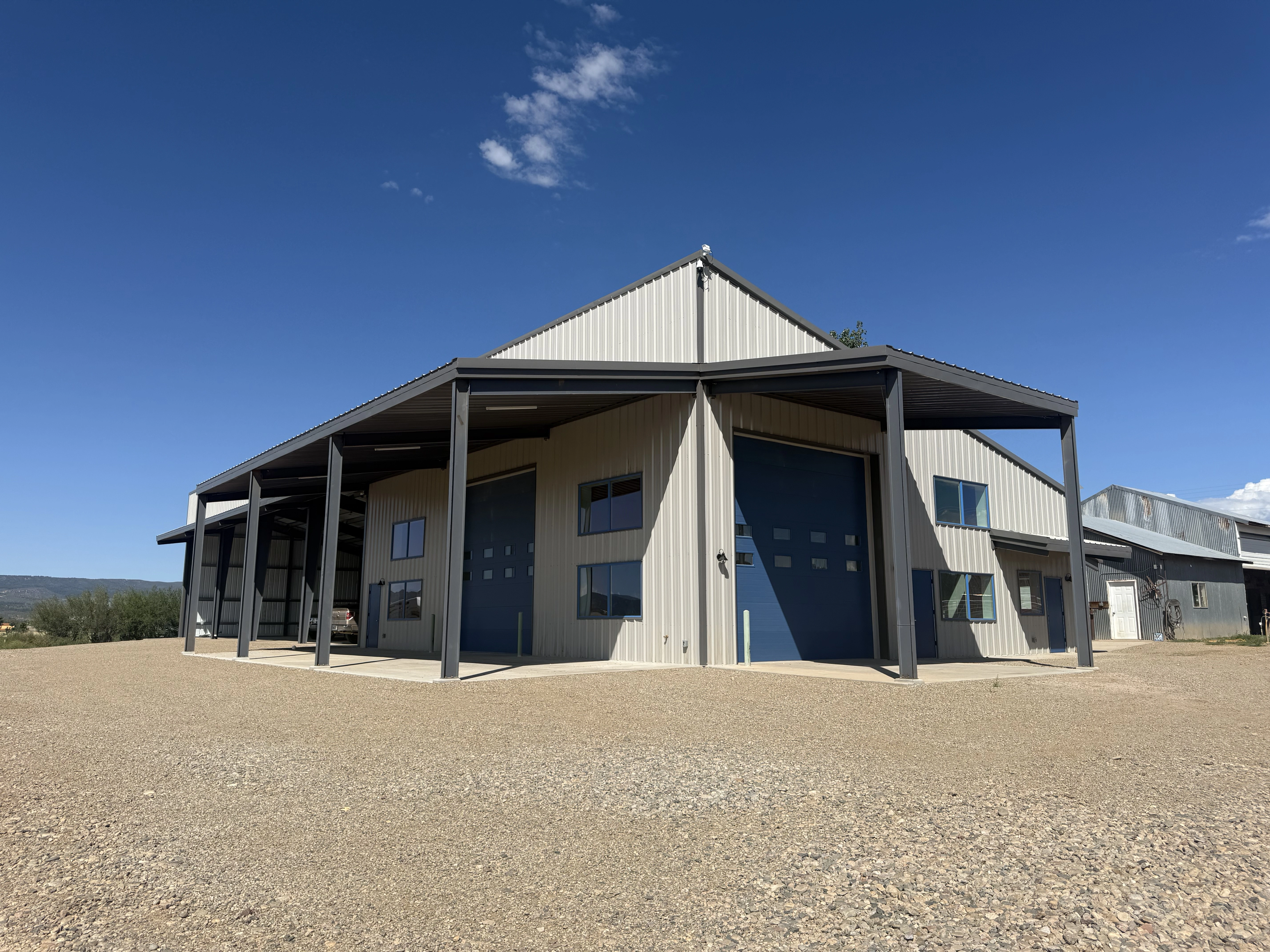 Modern grey storage building with blue garage doors