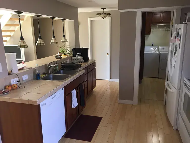 Kitchen with breakfast bar and adjacent laundry area