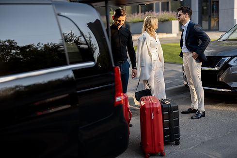 business-couple-near-minivan-taxi-with-suitcases-chauffeur.jpg
