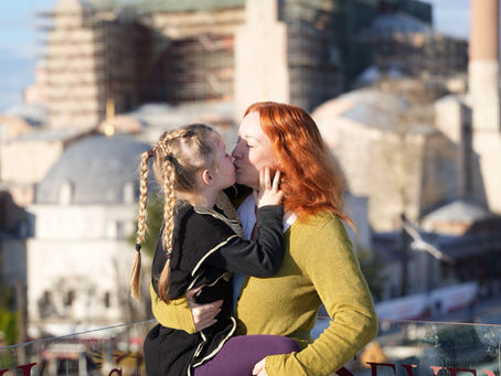Mum and young daughter kiss Istanbul