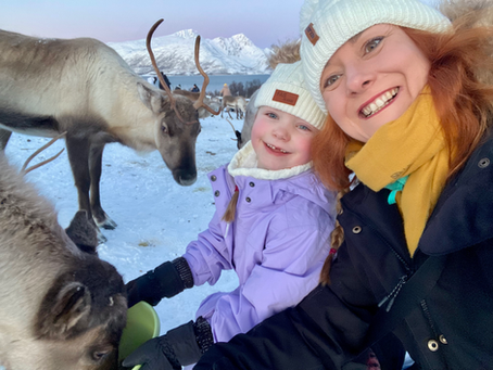 Mother and daughter with reindeer