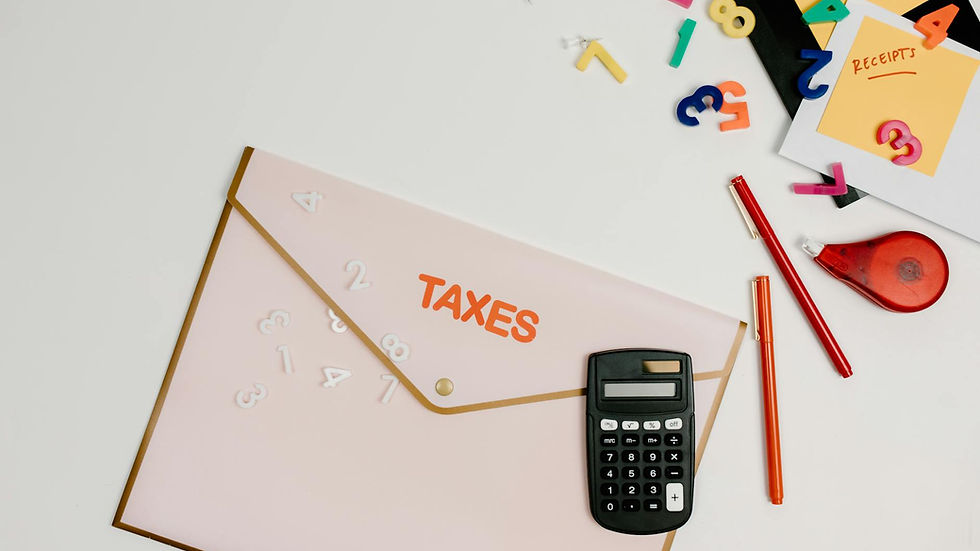 Flat lay of a tax preparation workspace with calculator, envelope, and colorful numbers.