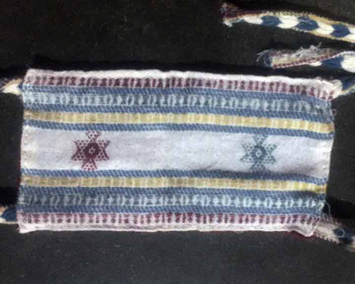 Close-up of a woven textile with geometric patterns and Desi Wool Bhujodi Shawl cksw062.