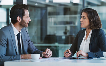 Man and woman delegating tasks in the office