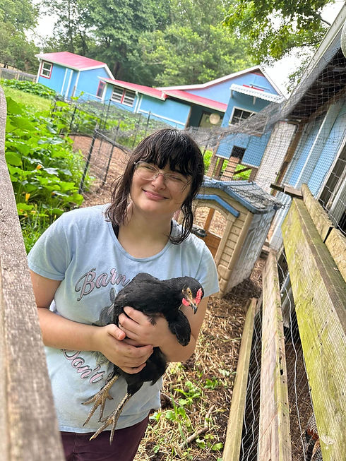 One of our trusted volunteers - Miss Katie, with a rescued rooster, named Eerie.