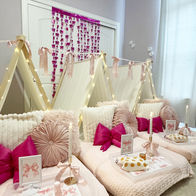 pink bow themed sleepover tents with candles, bows, and coquette decor