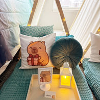 teal sleepover tents with capybara pillows and cozy themed decor