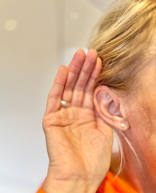 hand cupping the ear trying to help hear