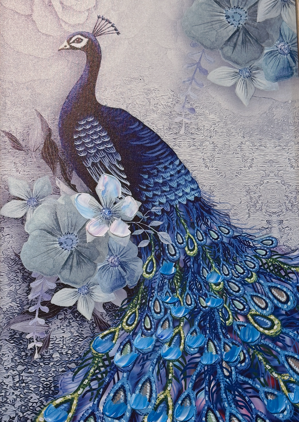 A peacock with vibrant blue feathers stands among large blue and white flowers, set against a textured background.