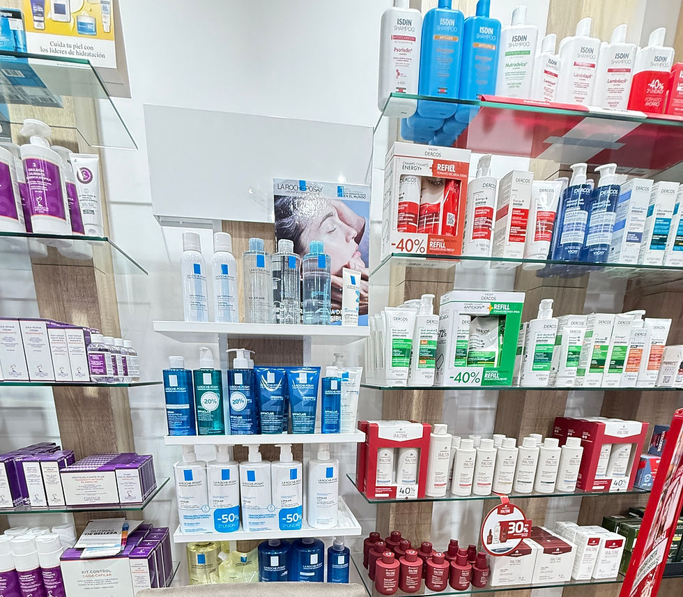 Pharmacy shelves lined with La Roche-Posay, Vichy, and Isdin shampoo bottles; Spanish sale signs and discount tags.