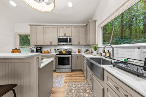 Kitchen with farmhouse sink and a large picture window over the counter