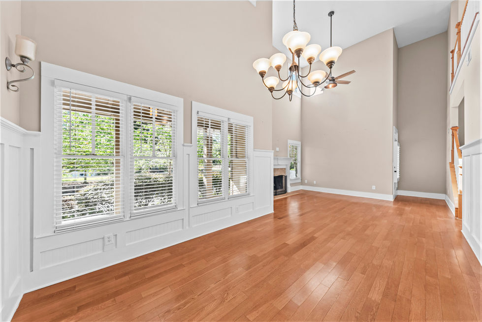 Dining room with plantation shutters, chandelier and wainscoting