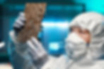 Woman inspecting micro chip that was manufactured.