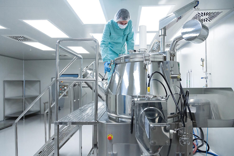 Man in liquid filling facility preparing the equipment for a new batch.