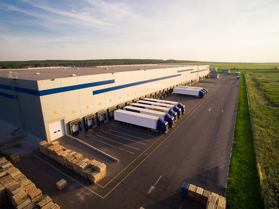Trucks dropping off inventory to a fulfillment center.