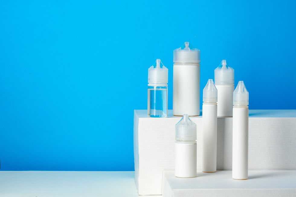 White bottles and containers on white platforms against a bright blue background, creating a clean and minimalistic look.