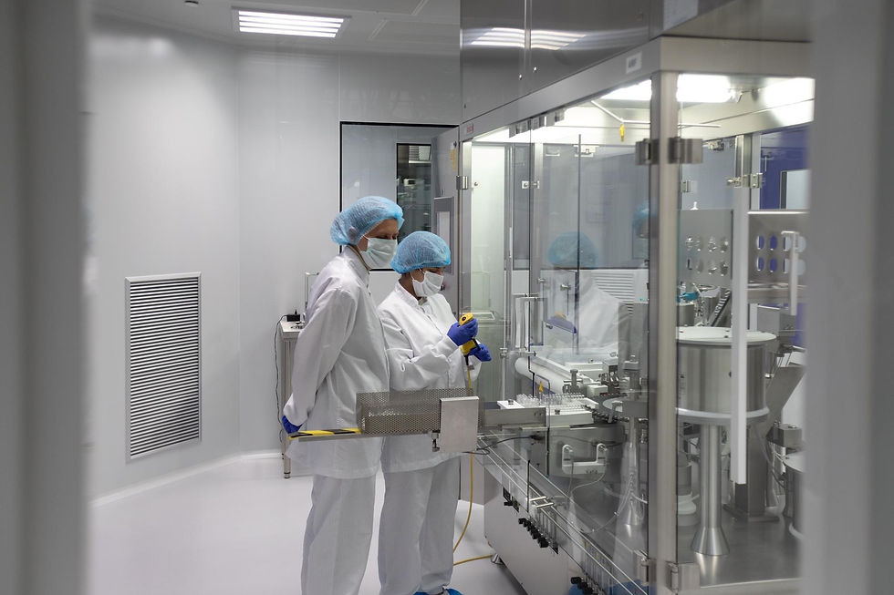 Two workers sterilizing a medical cleanroom.