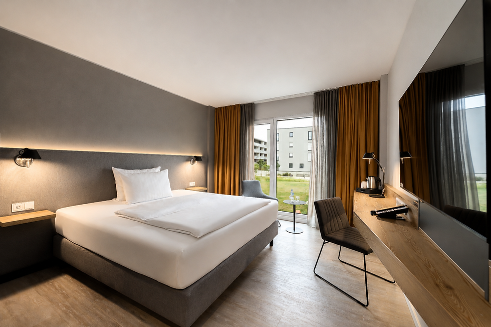 Bright hotel room with comfortable bedding at Piazza Aalen
