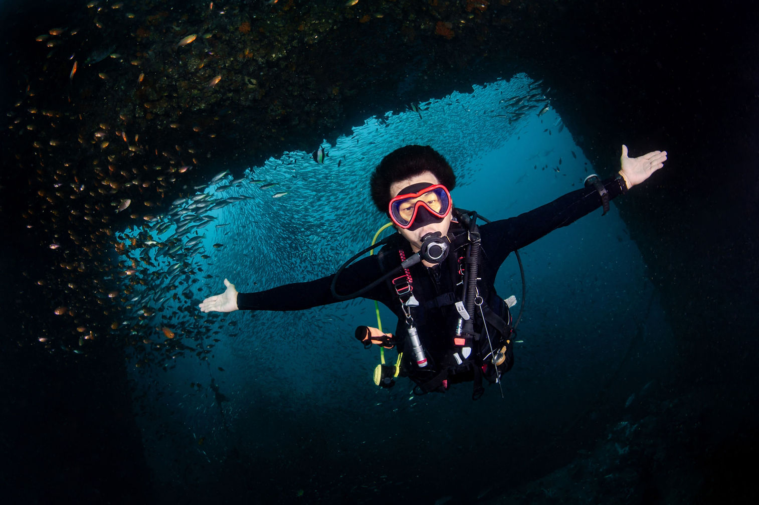 Scuba diver exploring the interior of the HTMS Chang, Thailand's largest shipwreck and artificial reef in Koh Chang.