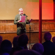 Man reads to audience