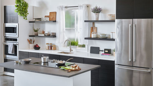 Standing Home Kitchen Set at 2010 Studios Los Angeles featuring matte black cabinets, stainless appliances, and dramatic studio lighting. Perfect for sleek branded content, commercials, and culinary video production.