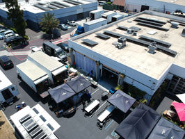 2010 studios has lots of parking and easy load in. Aerial view of 2010 Studios in Los Angeles with large on-site parking lot for full production needs. Plenty of space for production trucks, grip gear, crew vehicles, and catering tents. 2010 Studios offers professional film and TV stages, commercial kitchen sets, food photography studios, and green production facilities with secure parking and easy ground-level load-in.