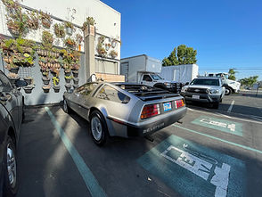 Silver DeLorean parked in lot