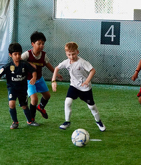 kids-playing-football-match-training
