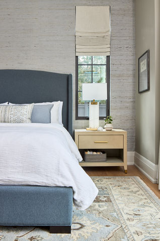 Calm bedroom designed by Frahm Interiors in Muskoka featuring natural light and cozy linens
