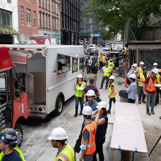Construction workers getting food from food truck