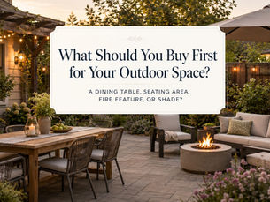 A warm garden patio with an outdoor dining table, lounge seating, fire feature, large shade umbrella, string lights, and text about what to buy first for an outdoor space.