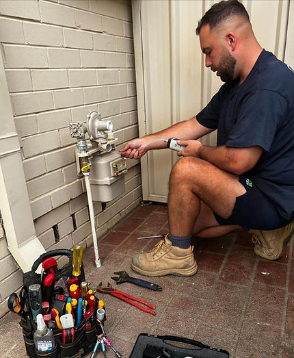 Plumber testing gas appliance