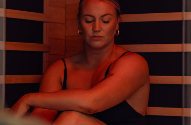 Infrared sauna with timber interior and ambient lighting at Mirador Springs Retreat wellness bathhouse