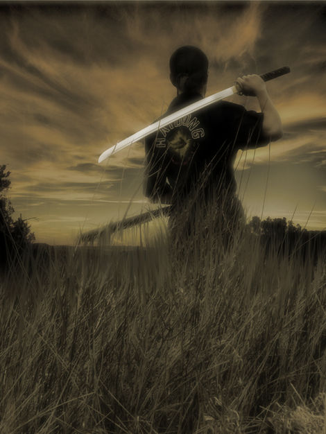 Ronin gazing at sunset with sword resting on shoulder