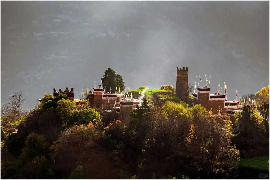 Ancient stone fortress with colorful flags on a lush hill, sunlit through mist. Tower and walls surrounded by dense trees, serene ambiance.