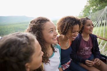 A group of teen girls sit and smile as they listen to their parent. Parent coaching in Summit County, CO can offer support with parenting therapy in Silverthorne, CO. Contact a parenting coach to learn more today! 80498 | 80424 | 80489