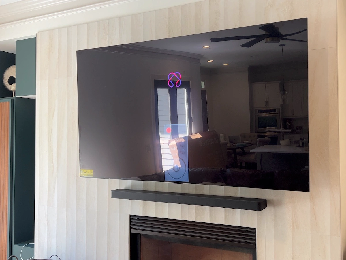 LG OLED TV mounted above a fireplace in Roswell, GA