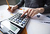 close-up-female-hand-counting-with-calculator.jpg