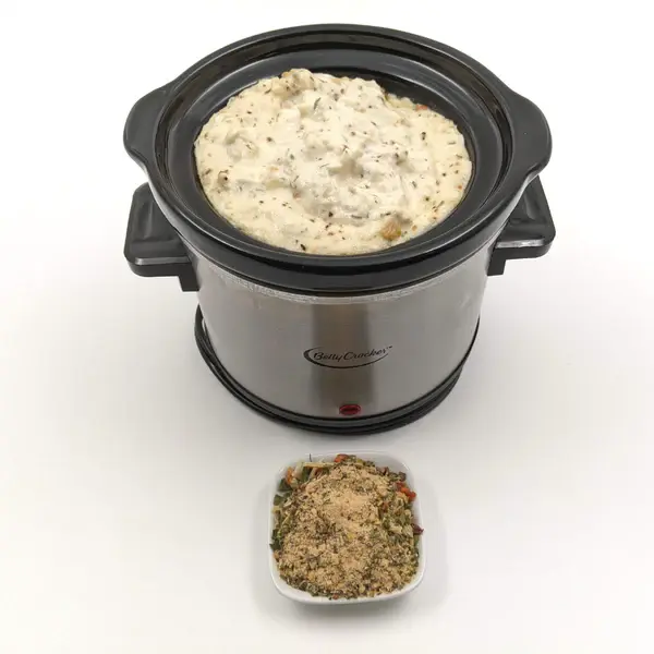 Thumbnail: Blended Baked Crab Spice Dip Mix in a mini sauce crockpot with the loose spices in a bowl