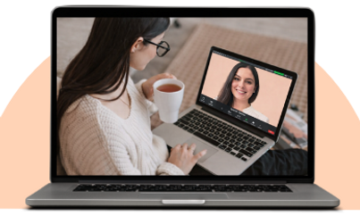 Adult woman holding a mug while attending a live online Spanish lesson on her laptop with her teacher visible on screen