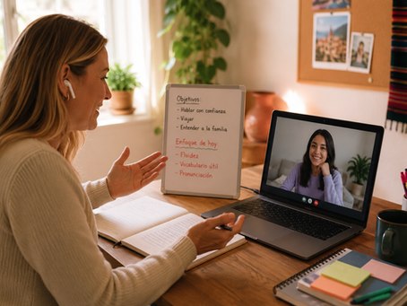 A Spanish teacher leads a one-on-one online lesson with an adult student over a video call. While discussing the student's goals, the teacher takes notes beside a planning board, illustrating a personalized approach to learning Spanish through conversation and individualized coaching.