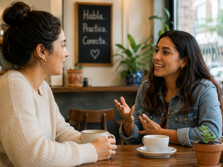 Adult Spanish learner practicing conversational Spanish with a native Spanish speaker during a relaxed conversation at a café.