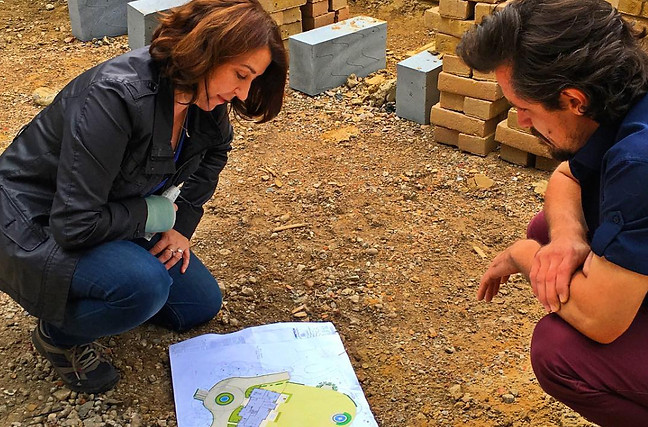 Pippa discussing design plan on site with a contractor
