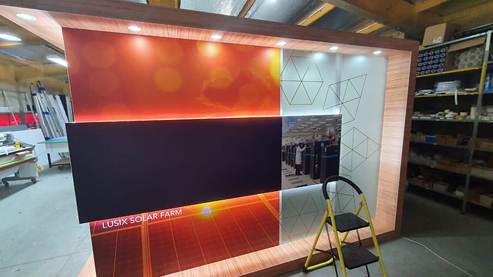 Custom-built backlit display stand with vibrant sunset graphic
