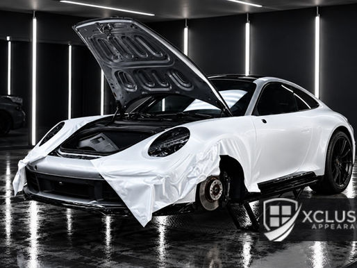 White sports car undergoing professional car vinyl wrap installation at Xclusive Appearance in Lawrenceville, GA.