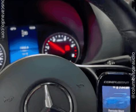 Mercedes dashboard and steering wheel with a smartphone displaying a remote start app. The image highlights how remote start and smartphone vehicle control can improve comfort and convenience before driving.