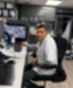 A picture of the owner and pharacist, Nithish Bambila sitting in his office.