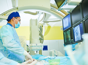Interventional radiology. surgeon radiologist at operation during catheter based treatment