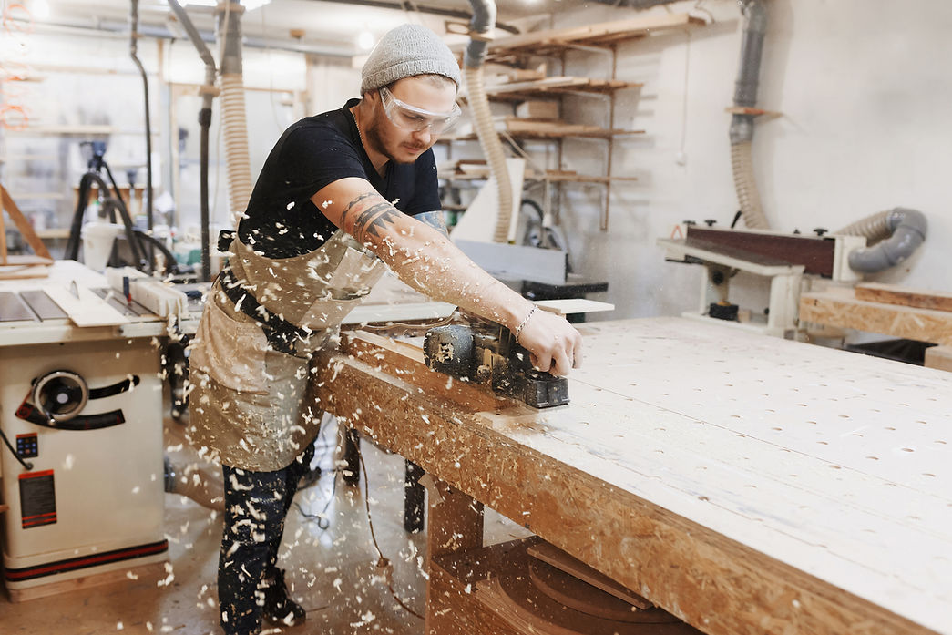 Woodworker Using Planer