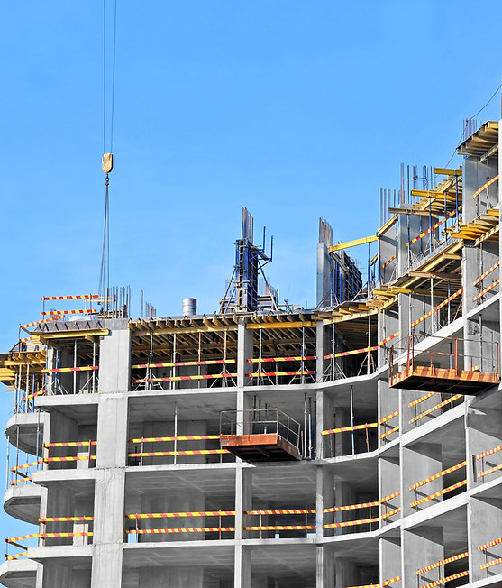 High-rise building under construction against a clear blue sky